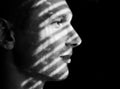 Face Of Handsome Man With Strips Of Light And Shadows On Her Face.