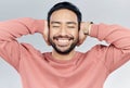 Face, happy and silence with a man in studio on a gray background to cover his ears while enjoying quiet. Noise, smile