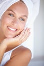 Face of happy woman, thinking or towel for skincare or wellness in bathroom for glow or detox. Morning, clean or