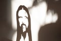 Face of jesus Christ shadow on the wall portrait