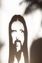 Face of Jesus Crist in shadow on the wall Royalty Free Stock Photo