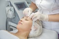 Face Lifting. Young woman getting facial massage in the cosmetology salon