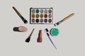 Face makeup cosmetics on brush, lipstick, foundation. on light background top view Royalty Free Stock Photo