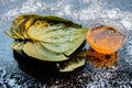 Face mask for controlling oiliness consisting of betel leaves, honey, sea-salt on a black wooden surface. Royalty Free Stock Photo