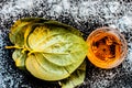 Face mask for controlling oiliness consisting of betel leaves, honey, sea-salt on a black wooden surface. Royalty Free Stock Photo