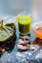 Face mask for controlling oiliness consisting of betel leaves juice, honey, sea-salt on a black wooden surface. Royalty Free Stock Photo