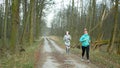 OLOMOUC, CZECH REPUBLIC, MARCH 13, 2020: Face masks coronavirus risk covid-19 couple women girls on training in running run forest