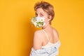 Face mask design with flowers. Portrait of beautiful woman with blue eyes, fashion make-up and mask on the orange Royalty Free Stock Photo