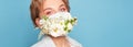 Face mask design with flowers. Portrait of beautiful woman with blue eyes, fashion make-up and mask over blue wall Royalty Free Stock Photo