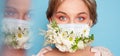 Face mask design with flowers. Portrait of beautiful woman with blue eyes, fashion make-up and mask over blue wall Royalty Free Stock Photo
