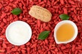 Face mask with goji berry ,yogurt and honey for skin treatment on boji berry background.top view,flat lay Royalty Free Stock Photo