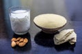 Face mask of multani mitti or mulpani mitti or fuller`s earth in a clay bowl on the wooden surface well mixed with milk and Royalty Free Stock Photo