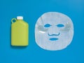 Face mask , reusable nwater bottle, cucumber, notepad on blue background. Dehydration.