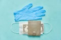 Face mask, rubber gloves and one dollar wallet. crisis and virus economics concept