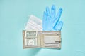 Face mask, rubber gloves and one dollar wallet. crisis and virus economics concept