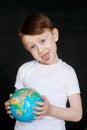 Face of a mask-wearing boy with fear in the eye Close-up on a gray background. Coronavirus and Air pollution concept. COVID-19 Royalty Free Stock Photo