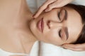 Face massage. Beautiful of young woman getting spa massage treatment at beauty spa salon.Spa skin and body care. Royalty Free Stock Photo