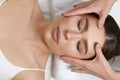 Face massage. Beautiful of young woman getting spa massage treatment at beauty spa salon.Spa skin and body care. Royalty Free Stock Photo