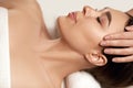 Face massage. Beautiful of young woman getting spa massage treatment at beauty spa salon.Spa skin and body care. Royalty Free Stock Photo