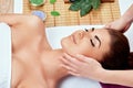 Face massage. Close-up of young woman getting spa massage treatment at beauty spa salon Royalty Free Stock Photo