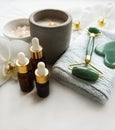 Face massage jade roller with cosmetic product