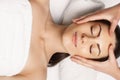 Face massage. people, beauty, spa, healthy lifestyle and relaxation concept - close up of beautiful young woman lying with closed Royalty Free Stock Photo