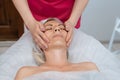 Face massage. Young woman getting spa massage treatment at beauty spa salon. Skin and body care. Facial beauty treatment Royalty Free Stock Photo