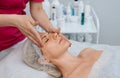 Face massage. Young woman getting spa massage treatment at beauty spa salon. Skin and body care. Facial beauty treatment Royalty Free Stock Photo