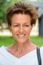 Face of mature beautiful woman with short hair thinking at the park Royalty Free Stock Photo