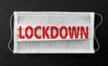 Face medical mask with word LOCKDOWN printed on it. Lockdown concept Royalty Free Stock Photo