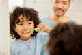 Face, mirror and child brushing teeth in a family home bathroom for health and wellness. Reflection of a latino boy kid Royalty Free Stock Photo