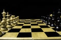 Face-off between black and white chess pieces on black background Royalty Free Stock Photo