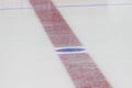 Face off blue spot with red line on hockey rink Royalty Free Stock Photo