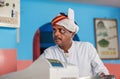 Face of older indian waiter of popular indian cafe with colorful interior