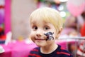 Face painting for cute little boy during kids birthday party Royalty Free Stock Photo