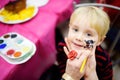 Face painting for cute little boy during kids birthday party Royalty Free Stock Photo