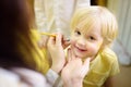 Face painting for cute little boy during kids merriment Royalty Free Stock Photo