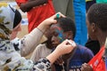 Face painting to local kids in Zanzibar