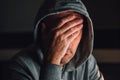 Face palm, man with hoodie covering face in dark room Royalty Free Stock Photo