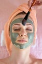 Face peeling mask, spa beauty treatment, skincare. Woman getting facial care by beautician at spa salon Royalty Free Stock Photo