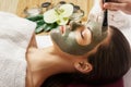 Face peeling mask, spa beauty treatment, skincare. Woman getting facial care by beautician at spa salon, side view, close-up.Spa c Royalty Free Stock Photo