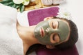 Face peeling mask, spa beauty treatment, skincare. Woman getting facial care by beautician at spa salon, side view, close-up.Spa c Royalty Free Stock Photo