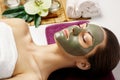 Face peeling mask, spa beauty treatment, skincare. Woman getting facial care by beautician at spa salon, side view, close-up.Spa Royalty Free Stock Photo