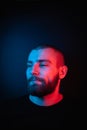 Face portrait of a bearded charismatic hipster. Stock photo studio close-up portrait on a dark background