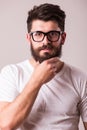 Face portrait of bearded man in glasses with hand on beard Royalty Free Stock Photo