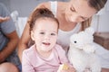 Face portrait of happy girl with mother, love and bonding in bedroom of home. Family, childhood and caring woman with Royalty Free Stock Photo