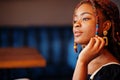 Face portrait of lovely african american woman with dreadlocks at cafe. Beautiful cool fashionable black young girl indoor Royalty Free Stock Photo