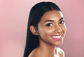 Face portrait, skincare and happy woman in studio isolated on a pink background mockup space. Natural, beauty and Indian