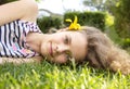 face portrait of a smiling teenage girl 12 years old lying on grass on sunny day Royalty Free Stock Photo