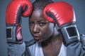 Face portrait of young angry and defiant black afro American sport woman in boxing gloves training and posing as a dangerous figh Royalty Free Stock Photo